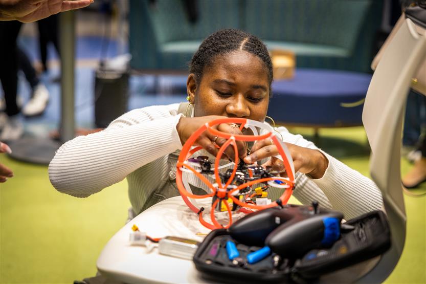 Middle and high school students learning about drone soccer